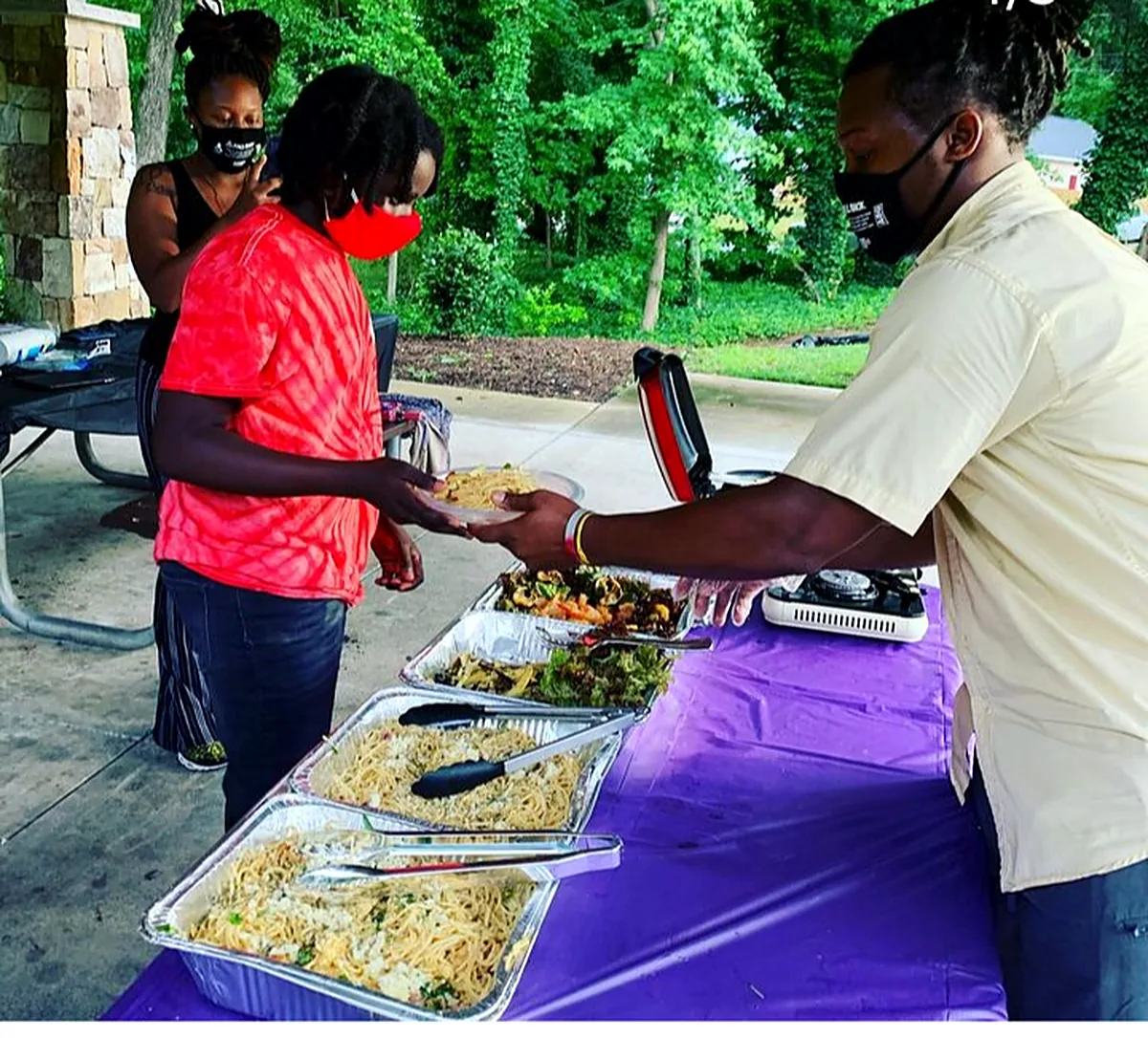 Serving a shared community meal outdoors